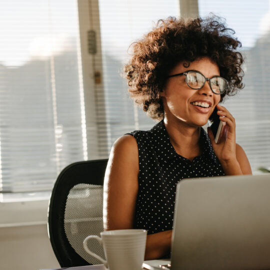 A photo of a woman using a mobile phone.