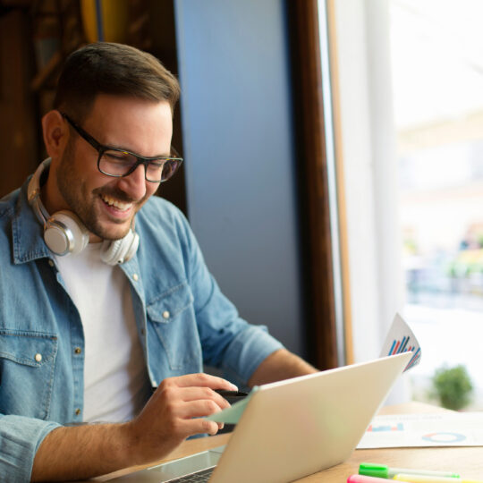 Photo of man using laptop